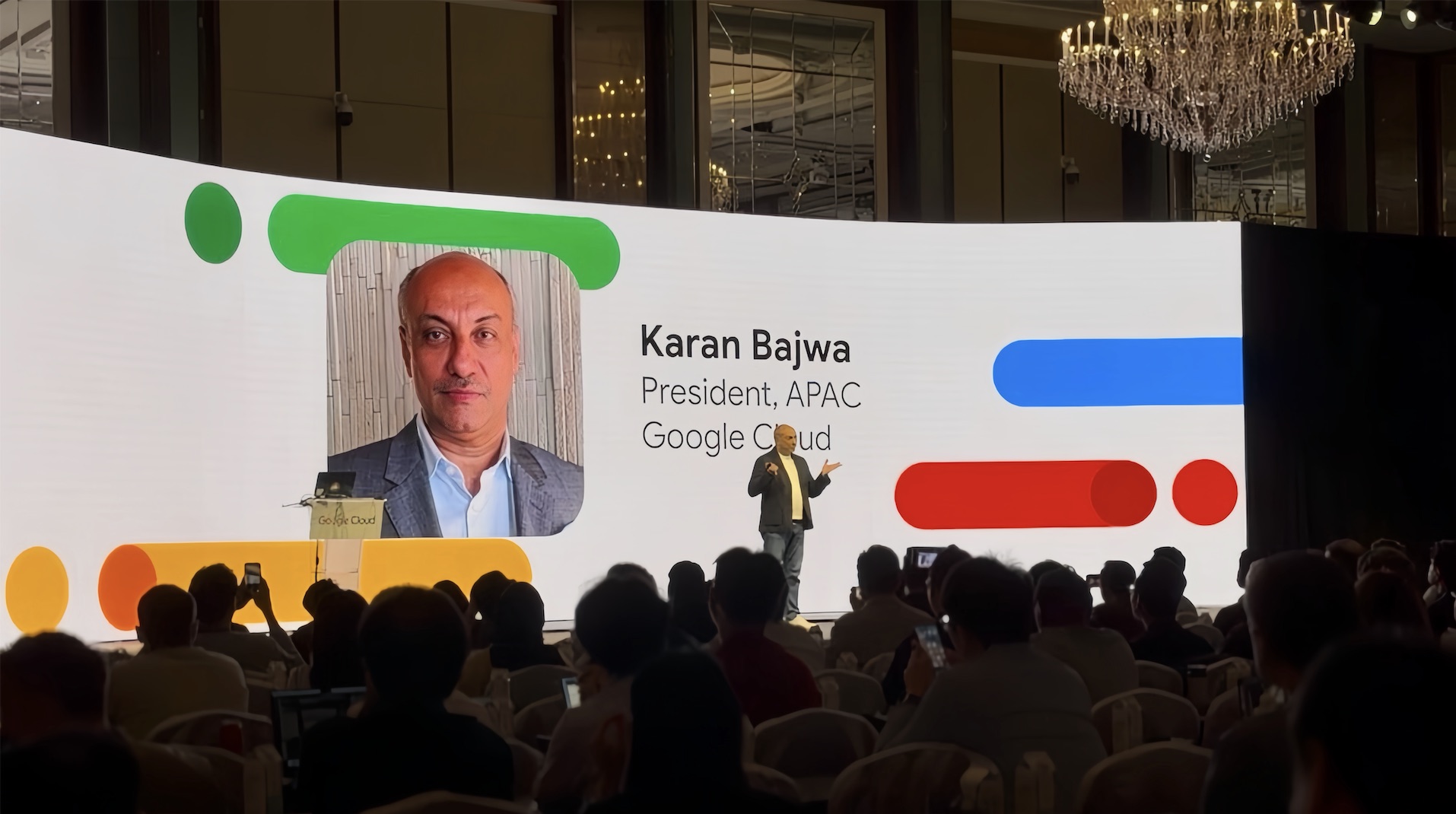 A speaker presenting on stage at the Google Cloud Summit in Singapore